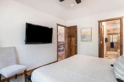 Primary bedroom with king-size bed and 55" Smart TV.
