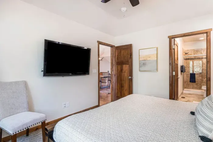 Primary bedroom with king-size bed and 55" Smart TV.