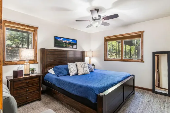 Guest bedroom # 3 in the lower level with a king size bed and ceiling fan.