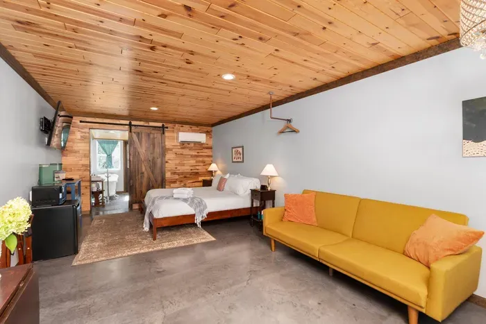 Yellow couch turns into a sofa bed for 2. Extra sheets and blankets are provided.