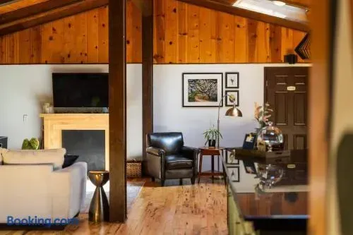 Warm, inviting living space with a cozy fireplace, plush seating, and stylish rustic details.