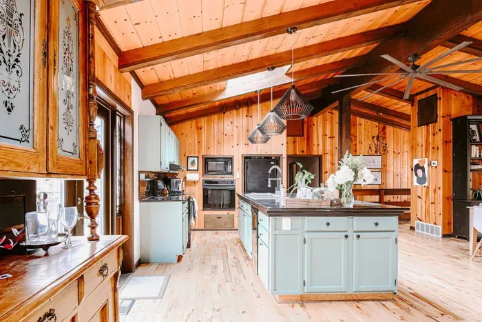 Bright, spacious kitchen with a large island, modern appliances, and warm wood accents.