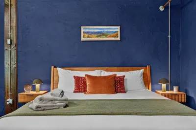 Comfortable bedroom with a king-size bed, fresh linens, soft pillows, and cozy blankets.