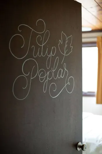 Decorative “Tulip Poplar” sign adding a personal touch to the space.