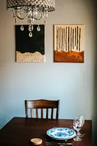 Intimate dining nook with rustic charm, elegant tableware, and a beautiful crystal chandelier.