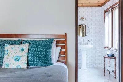 Cozy Bedroom & Bath: Comfortable bedroom with direct access to a bright, classic tiled bathroom.