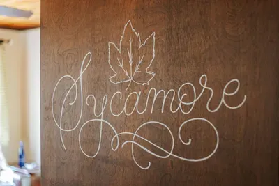 Decorative “Sycamore” sign adding a personal touch to the space.