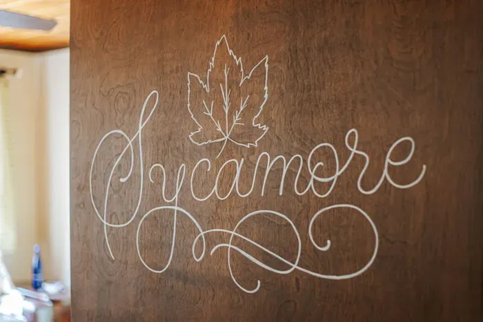 Decorative “Sycamore” sign adding a personal touch to the space.