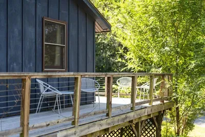 Private deck surrounded by lush greenery—perfect for enjoying a quiet morning or relaxing in the fresh mountain air.