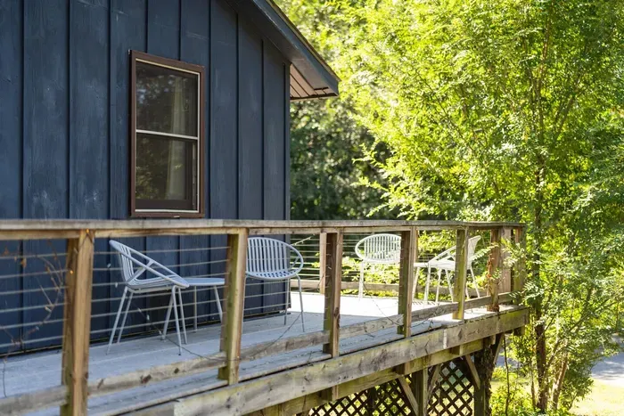 Private deck surrounded by lush greenery—perfect for enjoying a quiet morning or relaxing in the fresh mountain air.