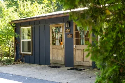 Charming wooded cabin entry with rustic doors and peaceful privacy