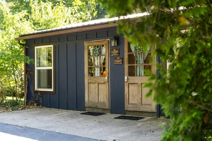 Charming wooded cabin entry with rustic doors and peaceful privacy