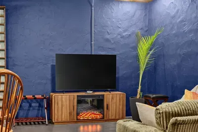 Cozy living area with a TV, comfortable seating, and warm wood accents.