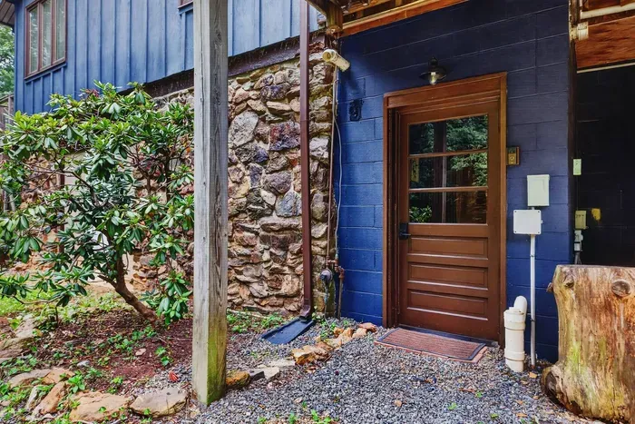 Entrance to the Garden Suite with a rustic stone and wood exterior.