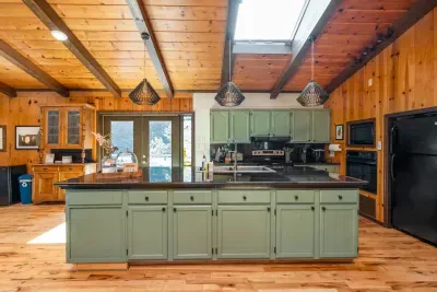 Fully equipped kitchen with a spacious island, modern appliances, and warm rustic charm.