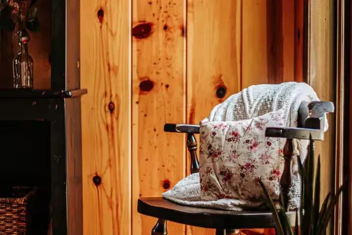 Cozy dining nook with a vintage chair, warm wood paneling