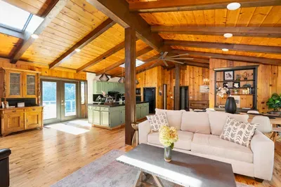 Spacious open-concept living area with warm wood accents, vaulted ceilings, and a bright, inviting atmosphere.
