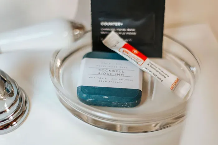 Thoughtful guest amenities featuring natural soap, toothpaste, and personal care essentials.