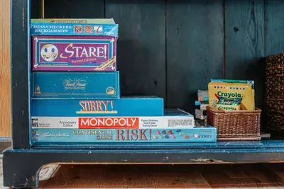 Fun-filled game shelf with board games, puzzles, and creative activities for all ages.