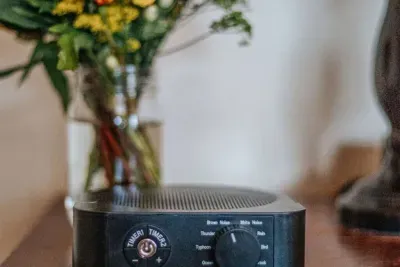 Cozy bedside sound machine offering soothing white noise and nature sounds for a restful stay.