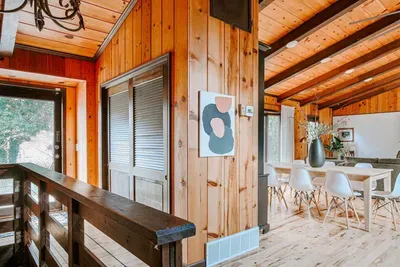 Warm wood-paneled interior with a cozy dining area, rustic details, and natural light.
