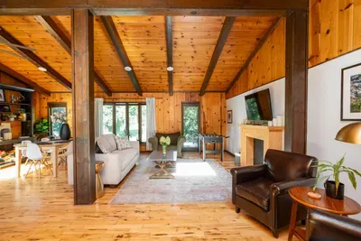 Cozy living room with warm wood accents, a fireplace, and plenty of natural light.