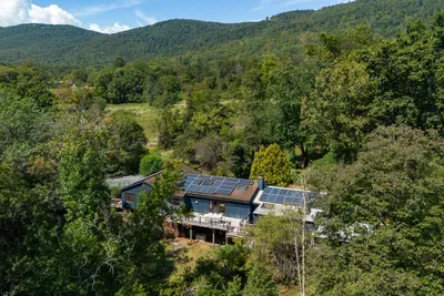 Peaceful mountain retreat surrounded by lush greenery and scenic mountain views.