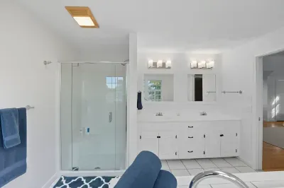 Primary ensuite with double sinks and stand-up shower