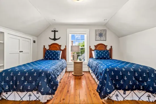 Third floor bedroom. Two twin beds & a dresser.