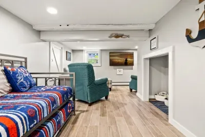 Basement extra living space. Two twin beds, a kids area, and a living room area with a smart TV.