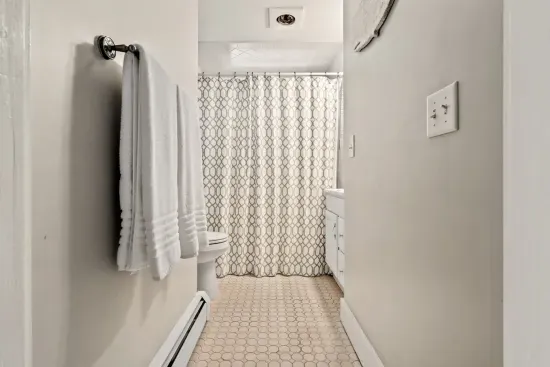 Second floor bathroom with bathtub with shower.