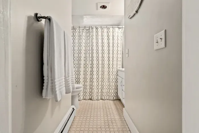 Second floor bathroom with bathtub with shower.