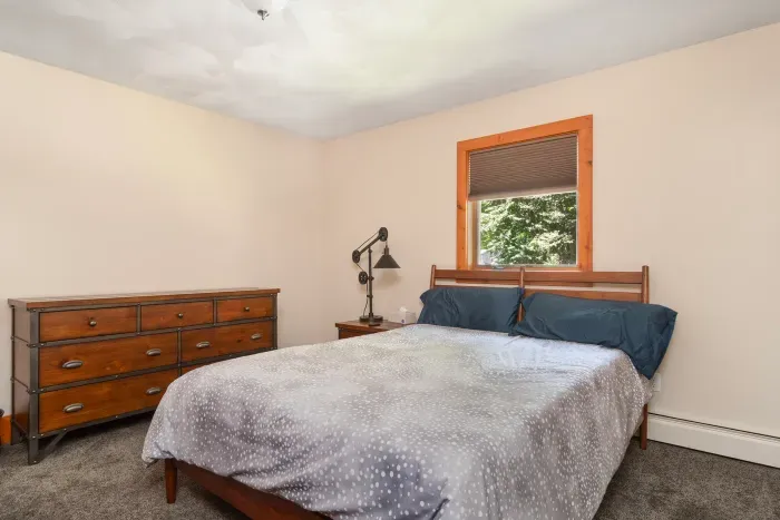Second bedroom with queen bed and dresser for guests to use