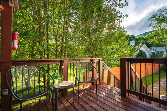 Private tree-lined deck with cozy seating for morning coffee