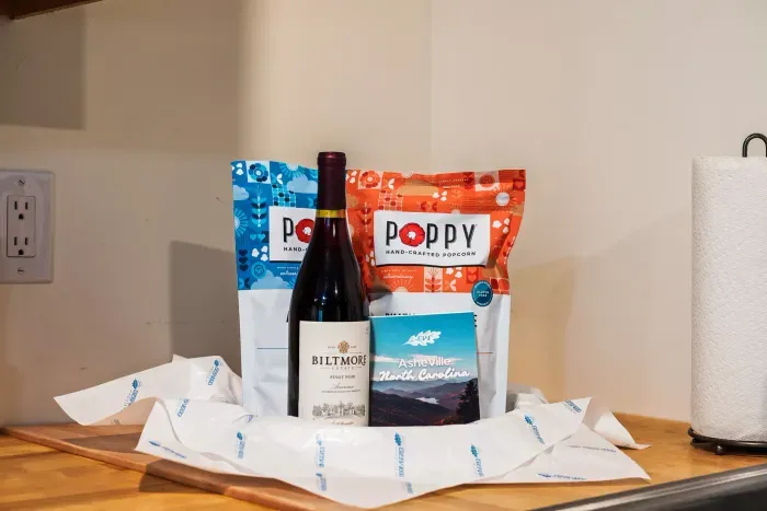 Locally inspired welcome treats with wine, popcorn, and Asheville charm