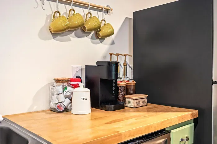 Charming coffee station with mugs, brewer, and warm wood countertop