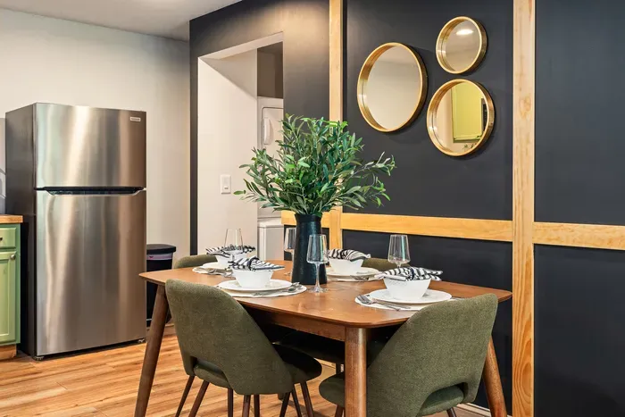 Modern dining nook for 4 with chic accent wall and designer touches