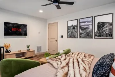 Cozy modern studio with plush seating, smart TV, and stylish decor