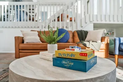 Cozy up in the living room with a selection of classic board games for family fun or a relaxing night in.  This inviting space is design for connection and entertainment.