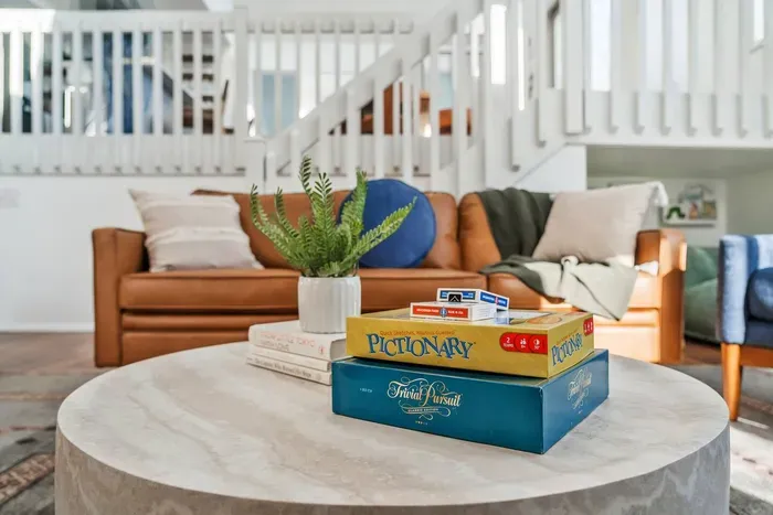 Cozy up in the living room with a selection of classic board games for family fun or a relaxing night in.  This inviting space is design for connection and entertainment.