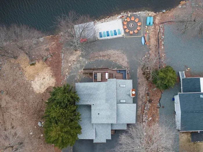 Bird’s-eye view of your private lakeside oasis—featuring direct water access, a spacious dock, cozy fire pit, and kayaks ready for your next adventure. Every inch of this property is designed for making memories year-round.