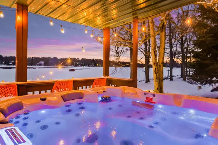 Soak in the warmth of the hot tub while enjoying breathtaking lake views.  Surrounded by twinkling string lights and a serene winter landscape, it's the perfect spot to unwind after a day of snow tubing, skiing, or outdoor adventures.