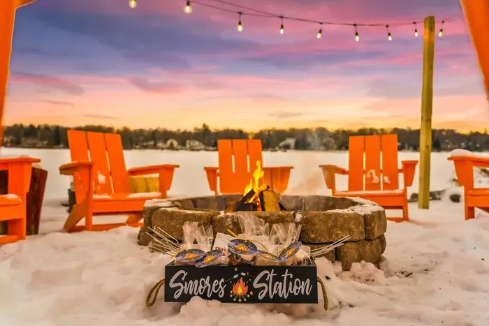 Unwind by the fire with stunning lake views and a cozy s'more station under a breathtaking winter sunset.  The perfect setting for family fun and relaxation.