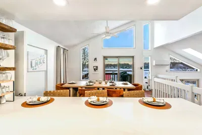 Soaring ceilings and panoramic lake views create the perfect backdrop for every season—from snowy mornings with coffee to golden summer sunsets shared over dinner.