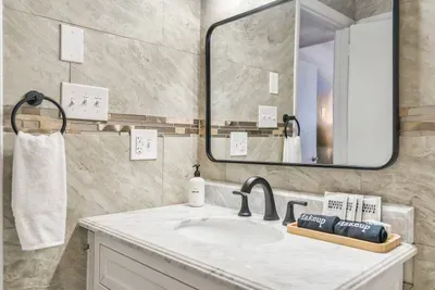 Sleek and spa-like with marble finishes,hand towels, and thoughtful extras like makeup cloths and toiletries—this second full bath is as functional as it is beautiful.