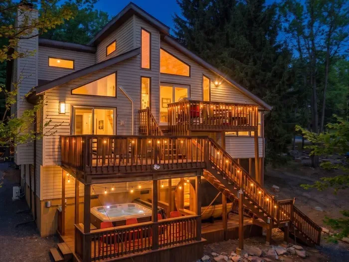 Multiple decks, a hot tub, barrel sauna and string lighting set the stage for evenings by the lake. Guests say there's no need to leave the property, and once you see the backyard in spring, you'll understand why.