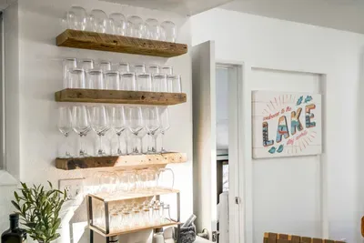 Cheers to lake days! Stocked with beautiful glassware and ready for wine nights or craft cocktails, this bar area makes hosting feel effortless and elevated.