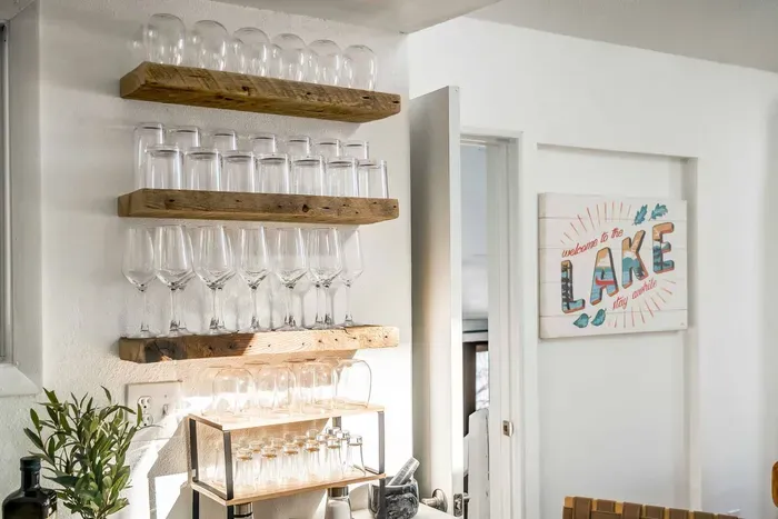 Cheers to lake days! Stocked with beautiful glassware and ready for wine nights or craft cocktails, this bar area makes hosting feel effortless and elevated.
