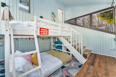 A kid-favorite bunk room with full-over-full beds, a slide for added fun, and cheerful lake-view windows. Max top bunk weight is 150 lbs—perfect for little adventurers ready to dream in style.