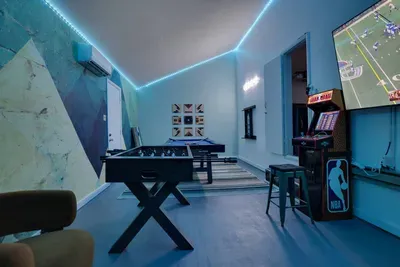 Level up your stay in the private game room featuring Pac-Man and NBA Jam arcades, pool, foosball, and a 75” smart TV. Perfect for movie nights, game days, or family fun — this Poconos lakefront retreat turns every night into playtime.